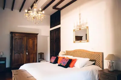 a bedroom with a bed and a chandelier at Finca Boutique el Diamante in Salgar