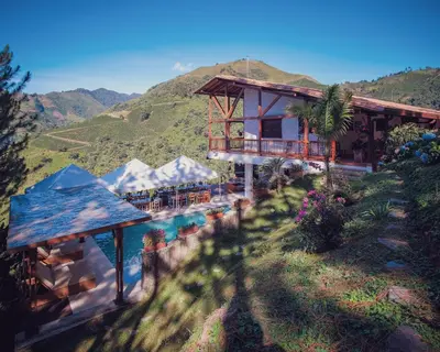 a house with a swimming pool and a mountain at Finca Boutique el Diamante in Salgar