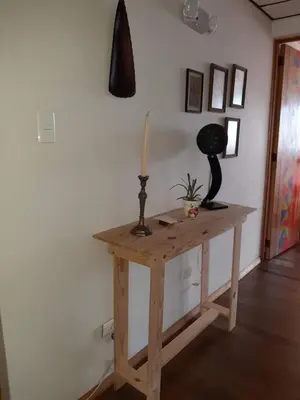 a wooden table with a lamp on top of it at Hostal Triangulo del Café in Manizales
