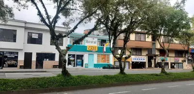a street with a building on the side of the road at Hostal Triangulo del Café in Manizales