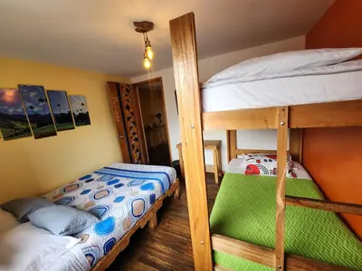 two bunk beds in a small room with at Hostal Triangulo del Café in Manizales
