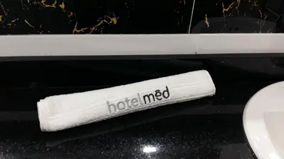 a roll of toilet paper sitting next to a toilet at Hotel Med Estadio in Medellín
