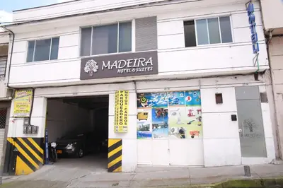 a building with a garage with a car in it at Hotel Madeira in Manizales