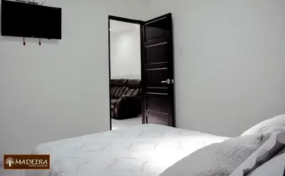 a bedroom with a mirror and a bed at Hotel Madeira in Manizales