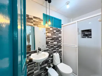 a bathroom with a sink and a toilet and a shower at Cabaña La Aldea - Santorini Colombiano in Doradal
