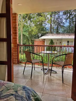 a patio with two chairs and a table on a balcony at Finca Turística de Alojamiento Rural Avalon in Jardin