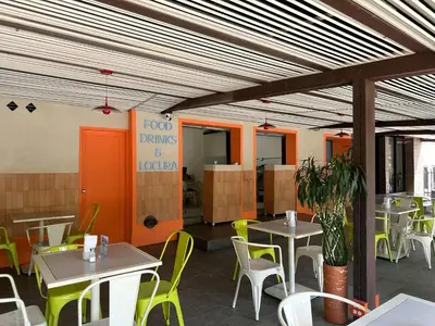 a restaurant with tables and chairs in a room at Hotel Santa Ana Medellin in Medellín