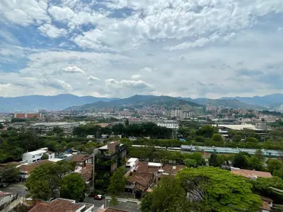 a view of a city with buildings and mountains at Hotel Santa Ana Medellin in Medellín