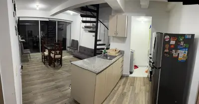 a kitchen with a refrigerator and a dining room at Apartasol de Lujo Santa Fe de Antioquia