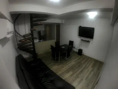 a living room with a couch and a dining room at Apartasol de Lujo Santa Fe de Antioquia