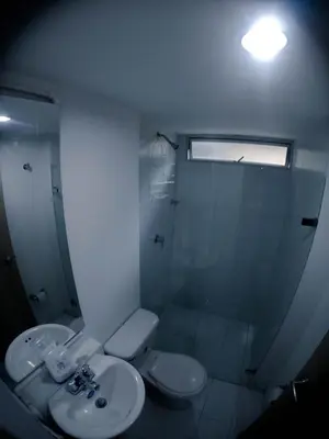 a bathroom with a toilet and a sink and a shower at Apartasol de Lujo Santa Fe de Antioquia