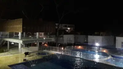 a view of a swimming pool at night at Apartasol de Lujo Santa Fe de Antioquia