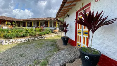 a house with a potted plant in front of a door at La Kolorina hotel campestre in Jericó