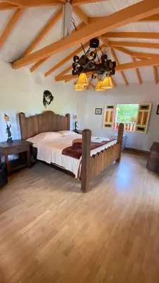 a bedroom with a large bed in a room at La Kolorina hotel campestre in Jericó