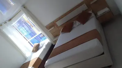 a bedroom with a bed and a window at Hotel Gutier Rionegro in Rionegro