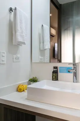 a bathroom with a white sink and a mirror at Epic Boutique Hotel in Medellín