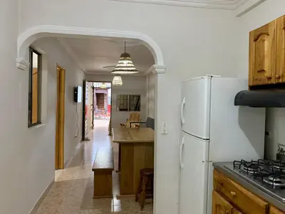 a kitchen with a white refrigerator and a counter top at Apartamentos Primavera in Jardin
