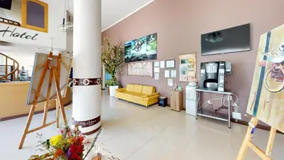 a salon with a yellow couch and a yellow chair at Hotel Villa Colonia in Marinilla
