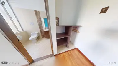 a small bathroom with a toilet and a mirror at Hotel Villa Colonia in Marinilla