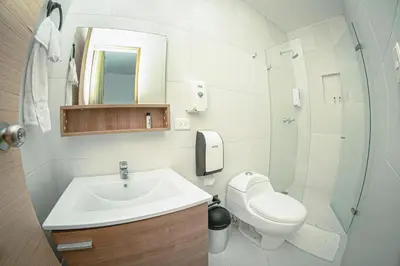 a bathroom with a sink and a toilet and a shower at Llanogrande Airport by Bernalo Hotels in Rionegro