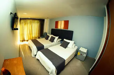 a hotel room with two beds and a window at Llanogrande Airport by Bernalo Hotels in Rionegro