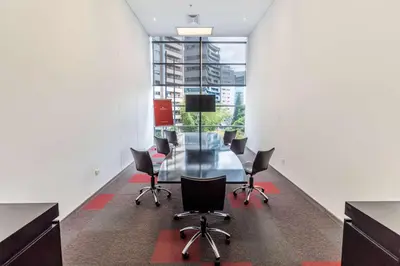 an office with a glass table and chairs at NH Collection Medellin Royal in Medellín