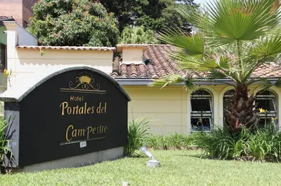 a sign for a car park in front of a house at Hotel Portales Del Campestre in Medellín