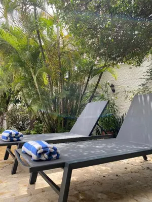 two picnic tables with blue and white pillows on them at Hotel Portales Del Campestre in Medellín