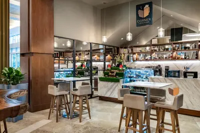 a restaurant with stools and tables in a room at Medellin Marriott Hotel in Medellín