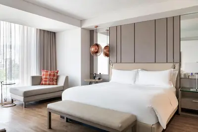 a bedroom with a large white bed and a chair at Medellin Marriott Hotel in Medellín