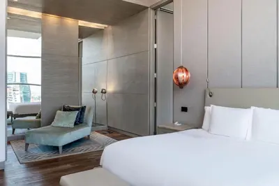 a hotel room with a bed and a chair at Medellin Marriott Hotel in Medellín