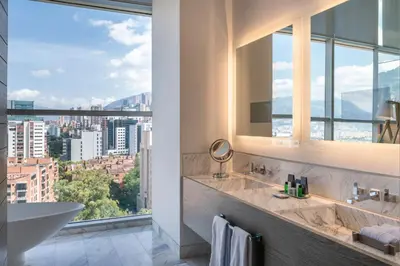 a bathroom with a tub and a sink and a window at Medellin Marriott Hotel in Medellín