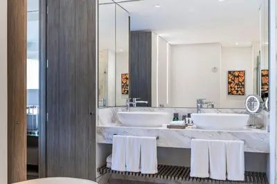 a bathroom with two sinks and two mirrors at Medellin Marriott Hotel in Medellín