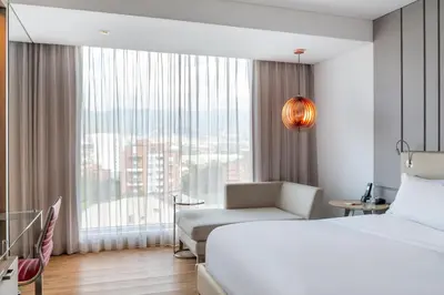 a hotel room with a bed and a window at Medellin Marriott Hotel in Medellín