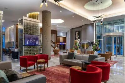 a lobby of a hotel with red chairs and couches at Medellin Marriott Hotel in Medellín