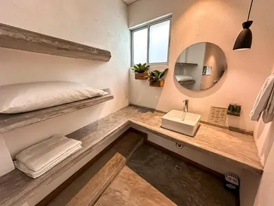 a room with a bed and a sink and a mirror at Los Colores Ecoparque in Doradal