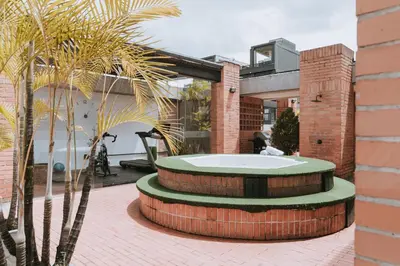 a building with a bath tub in a courtyard at Travelers Orange Suites in Medellín