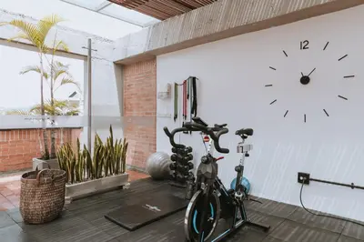 a room with a bike and a clock on the wall at Travelers Orange Suites in Medellín