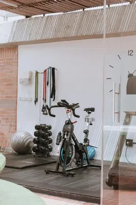 a gym with two exercise bikes in a garage at Travelers Orange Suites in Medellín
