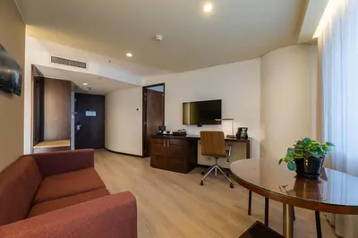 a living room with a couch and a table at Hotel Estelar Milla De Oro in Medellín