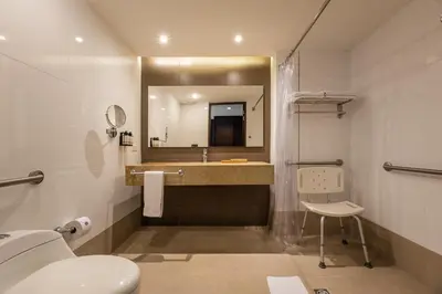 a bathroom with a sink and a toilet and a mirror at Hotel Estelar Milla De Oro in Medellín
