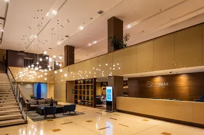 a lobby of a hotel with a sign on the wall at Hotel Estelar Milla De Oro in Medellín