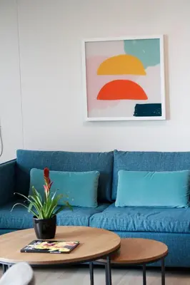 a blue couch in a living room with a coffee table at Estelar Apartamentos Medellin in Medellín