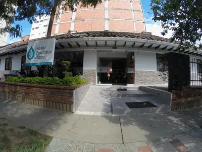 a building with a sign in front of it at Hotel Boutique Plaza in Medellín