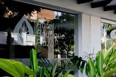 a window of a store with a sign in it at Hotel Boutique Plaza in Medellín
