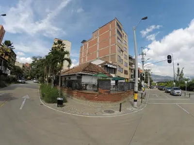 a building on the corner of a city street at Hotel Boutique Plaza in Medellín