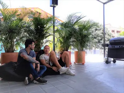 a group of three people sitting on the ground at Noah boutique hostels Medellín in Medellín