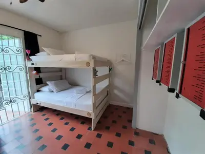 a room with two bunk beds and a window at Noah boutique hostels Medellín in Medellín