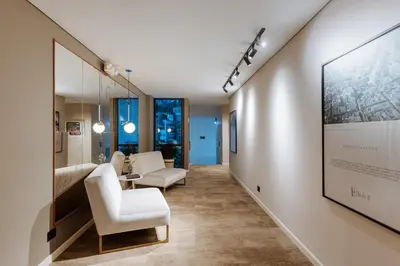 a hallway with two chairs and a wall with a picture at 1616 Hotel in Medellín