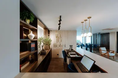 an office with a desk and a laptop on a counter at 1616 Hotel in Medellín